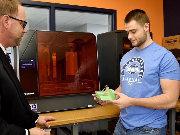 Dylan Treaster discussing a 3D printed part with North Central PA LaunchBox director Brad Lashinsky